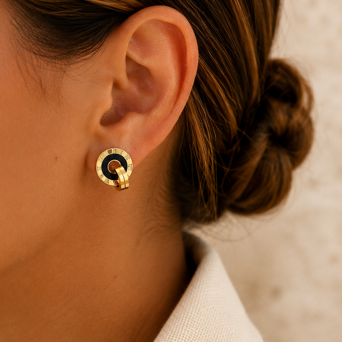 Gold Roman numeral stud earrings with black acrylic centre, 18K gold plated 316 stainless steel and curved layered detail.