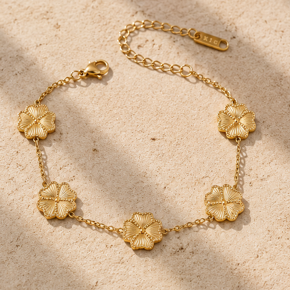 Gold flower chain bracelet with textured floral charms and adjustable extender chain.