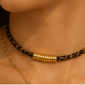 Leopard suede choker necklace with gold-tone centre accent and adjustable extender chain.